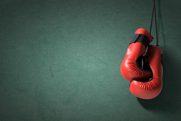 Red boxing gloves hanging on wall