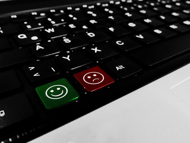 Happy and sad emoji keys on keyboard