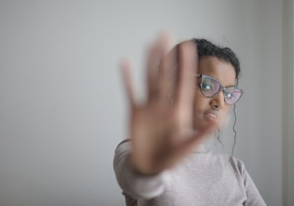 Woman holding up the palm of her hand towards the viewer