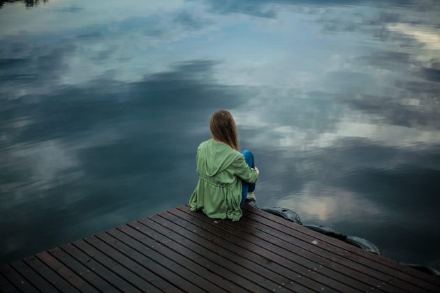 Girl sitting alone on dock