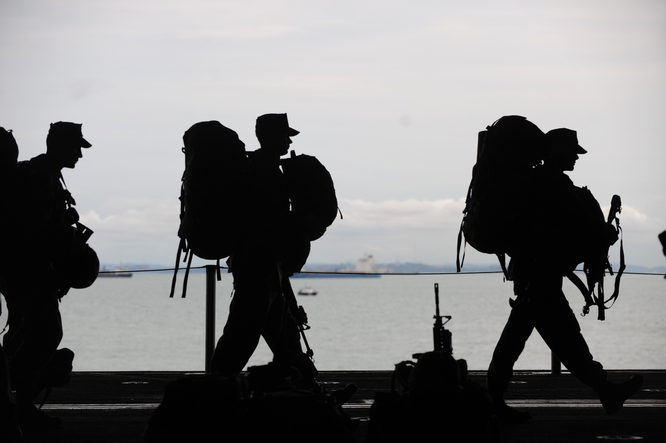 Silhouette of Military Personnel Walking On Ship