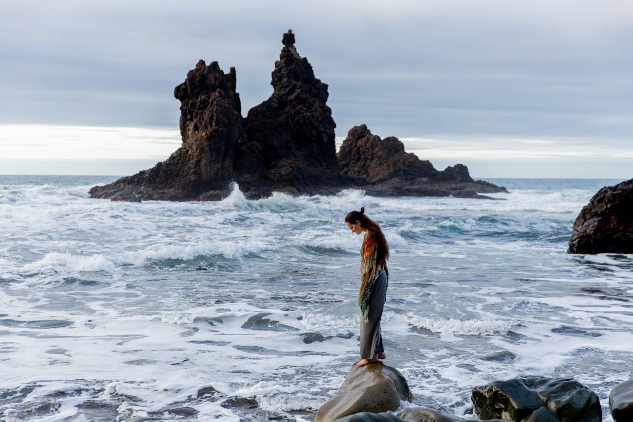 Woman alone on rock at the beach