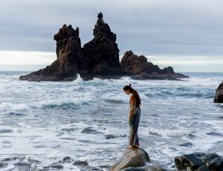 Woman alone on rock at the beach